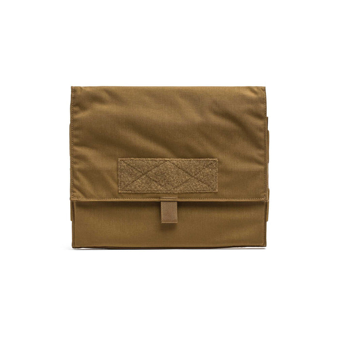 The Ammo Book is a tan, rectangular pouch made of durable ripstop nylon with a flap closure and a small Velcro patch on the front.