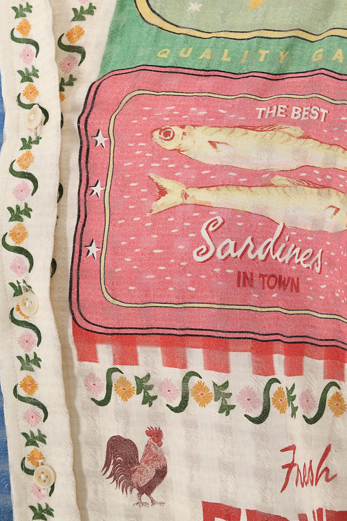 Anastasia shirt in cream with vintage-inspired print featuring sardine tin graphic, rooster, pattern detail vines, and checkered borders
