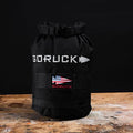 GORUCK black rucking sandbag with American flag patch on rustic wooden table