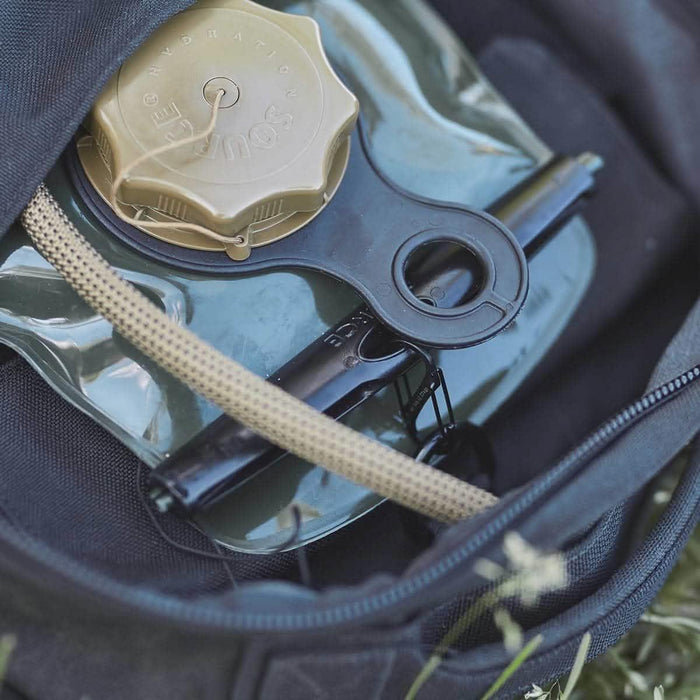GORUCK carabiner attached to hydration bladder and tube inside rucksack outdoors