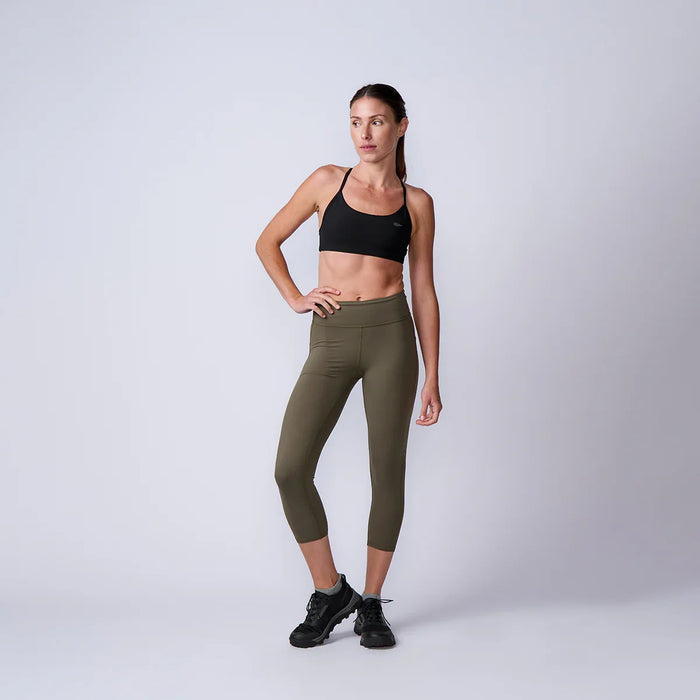 Woman in athletic wear modeling GORUCK olive leggings and black sports bra on white background
