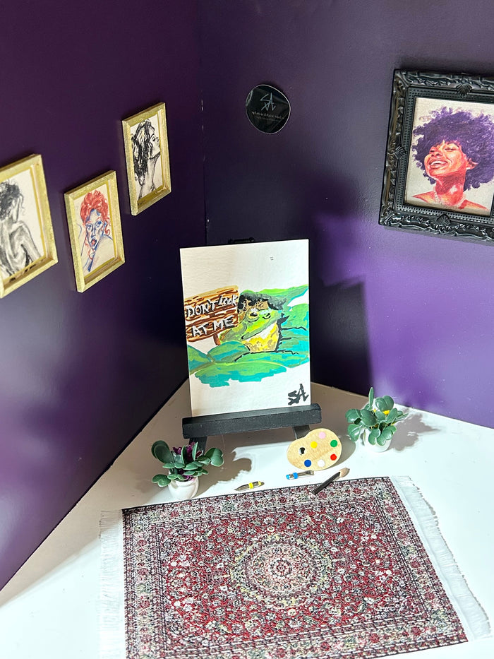Don't Look At Me miniature frog artwork displayed in an art room