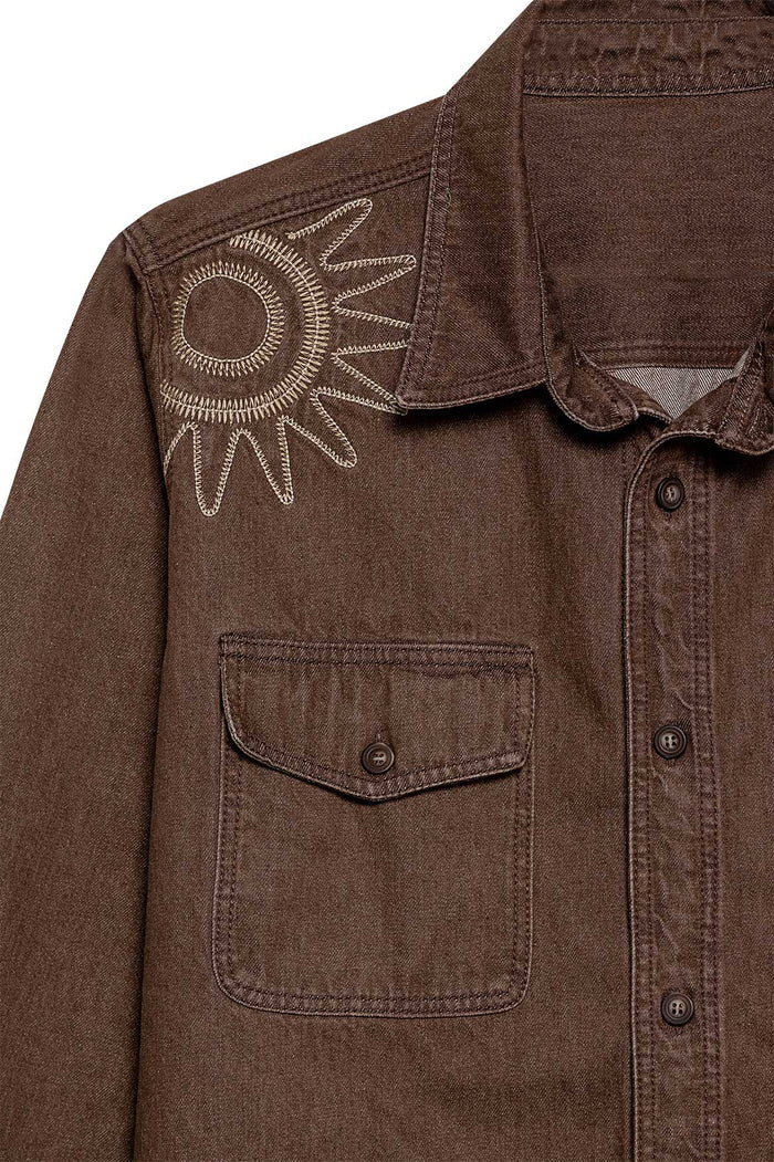 Brown button-front shirt with flap pockets and embroidered sun detail on shoulder