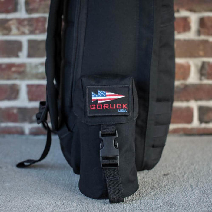 GORUCK black rucksack side with full-panel water bottle pocket and GORUCK USA patch