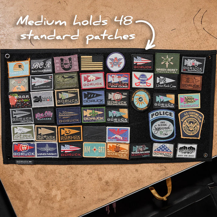 GORUCK medium patch board displaying 48 colorful rucking and event patches on a table.