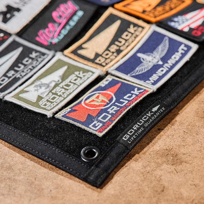 GORUCK patch board displaying various colorful rucking gear patches on a black panel