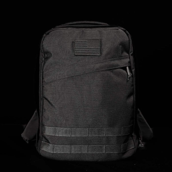 GORUCK black rucksack with American flag patch, durable tactical backpack on black background