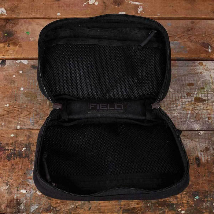 GORUCK black FIELD pocket organizer with mesh zippered compartments on rustic wood