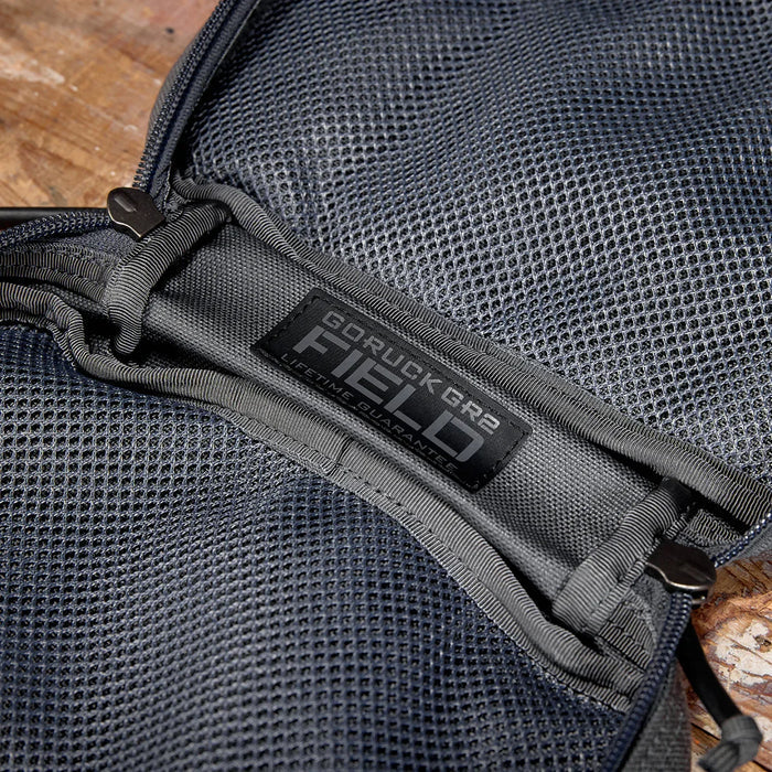 Closeup of GORUCK GR2 Field Pocket in Armor Grey, showcasing durable mesh and zipper details.