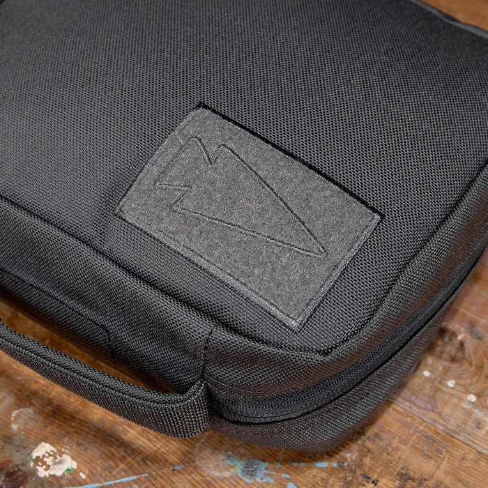 GORUCK padded field pocket in Armor Grey durable fabric on wooden surface