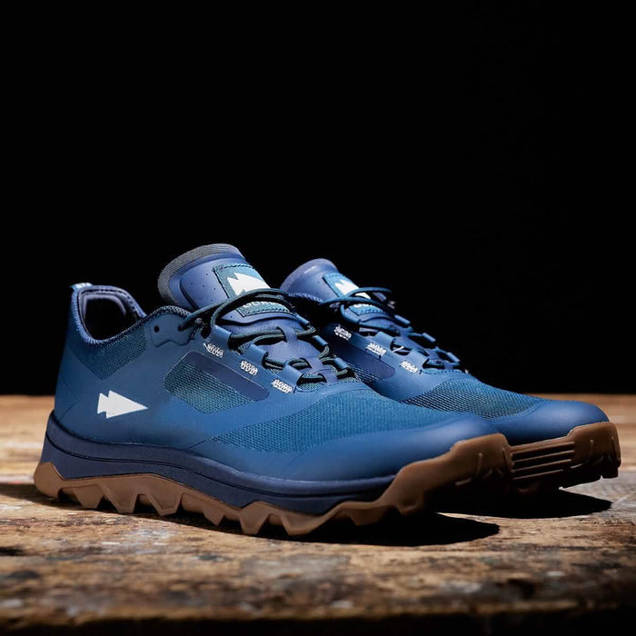 GORUCK blue rucking shoes with rugged soles on wooden surface, tough outdoor footwear