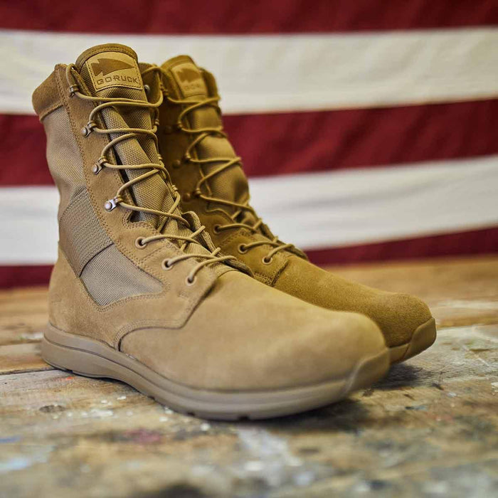 GORUCK coyote brown tactical boots on a rustic wooden surface with American flag background