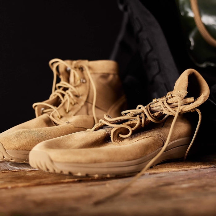 GORUCK tan suede rucking boots on wooden surface, rugged outdoor footwear