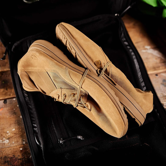GORUCK tan rucking shoes on black backpack, tough outdoor footwear for rucking
