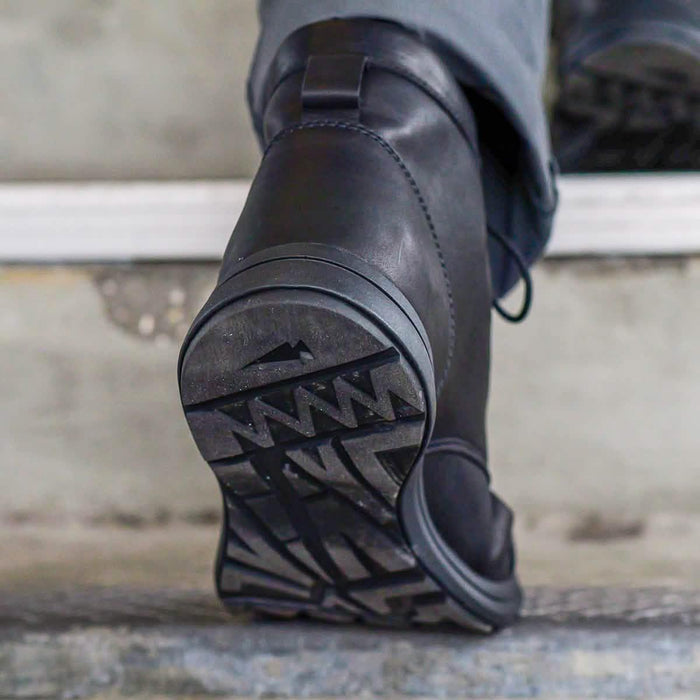 GORUCK black leather boot with rugged sole close-up on concrete steps