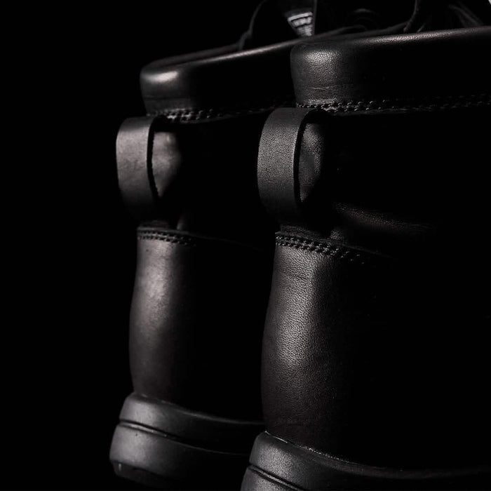 Close-up of black GORUCK rucking boots with rugged leather design and reinforced stitching.