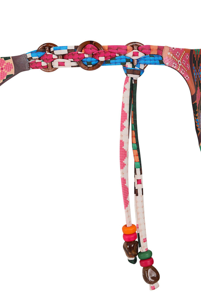 Maisie bikini bottom with multicolored geometric print, wooden ring details, adjustable tie straps with pink, orange and green bead accents