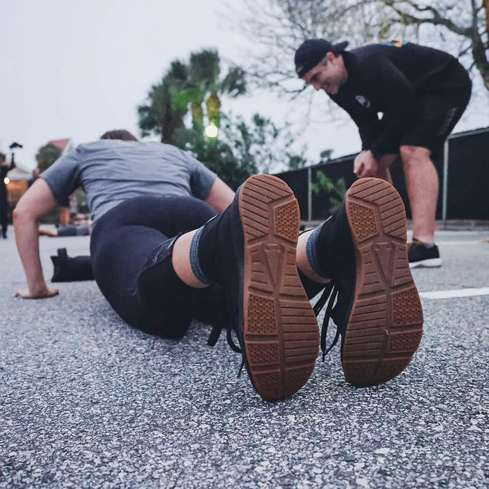 GORUCK rucking boots during outdoor fitness training, person doing push-ups on pavement