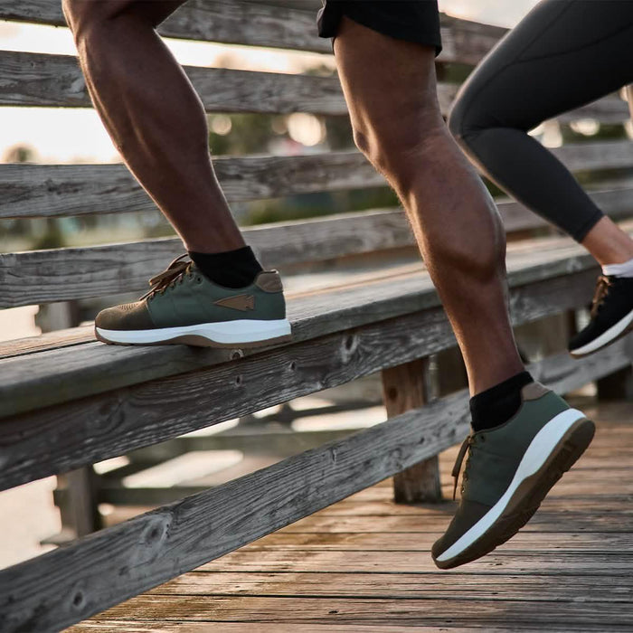 Man wearing GORUCK men’s Ranger shoes running outdoors on wooden steps, close-up legs