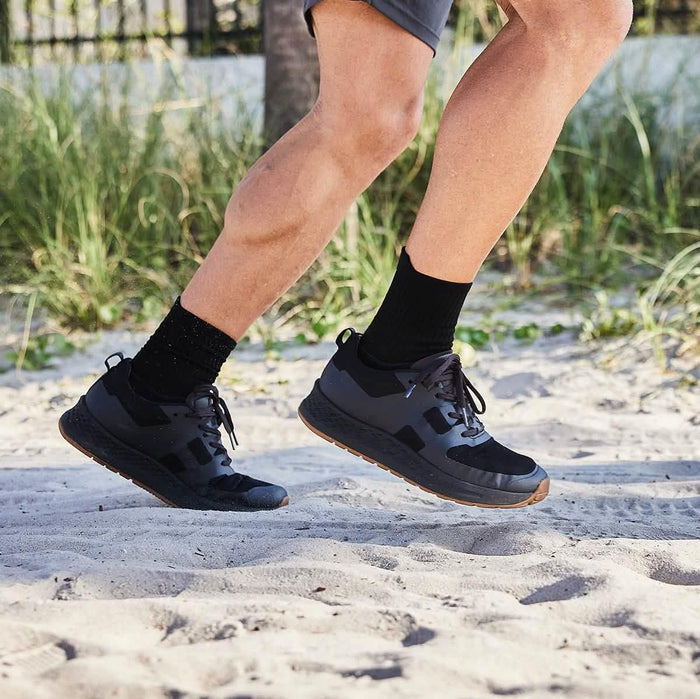 GORUCK black rucking shoes on person running in sand, outdoor fitness gear