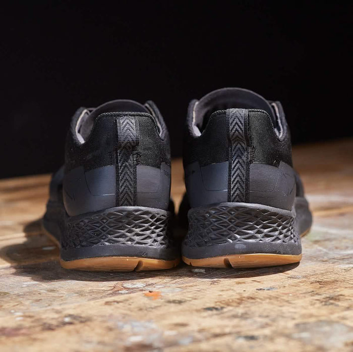 GORUCK black rucking shoes rear view on wooden surface, durable sole design