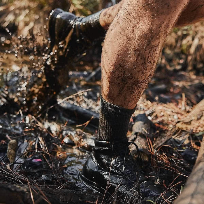 GORUCK rucking boots and Merino socks splashing through muddy outdoor terrain