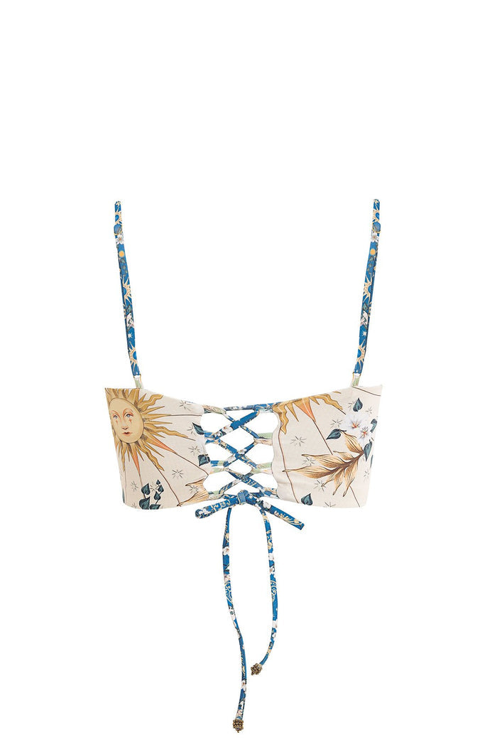 Reversible bandeau bikini top with adjustable straps, cream base with sun and leaf print and blue lace-up detail at center front