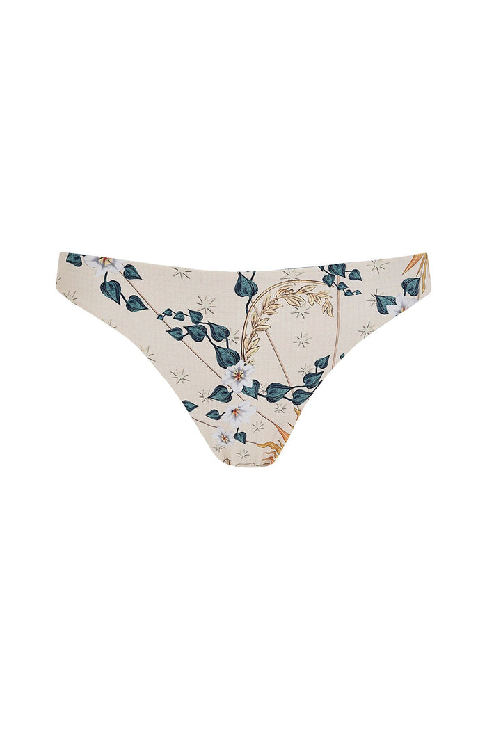 Nader Ilu bikini bottom in cream with botanical print of teal leaves, wheat stems, and small star shapes