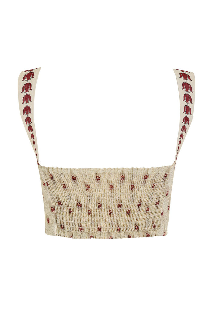 Nader Lupe crop top in cream with red bell-shaped pattern detail print on wide straps and smocked bodice with scattered pattern