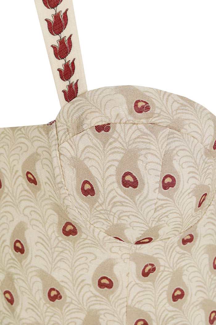 Nader Lupe crop top in cream with burgundy palm fronds and circular print, featuring wide straps with repeated tulip pattern