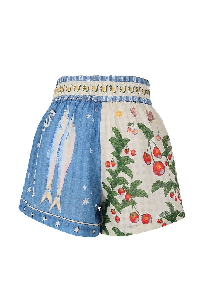 Nalia Shorts with elastic waist, featuring blue panel with white stars and cream panel with red cherries and green leaves print