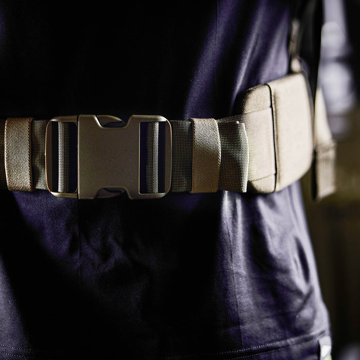 Close-up of a person wearing the Padded Hip Belt in tan with a large buckle over a dark shirt—designed for comfort and support during rucking.