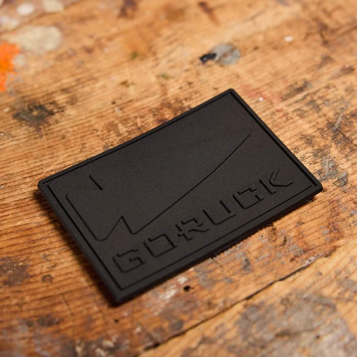 GORUCK black patch with knife design on rustic wooden surface