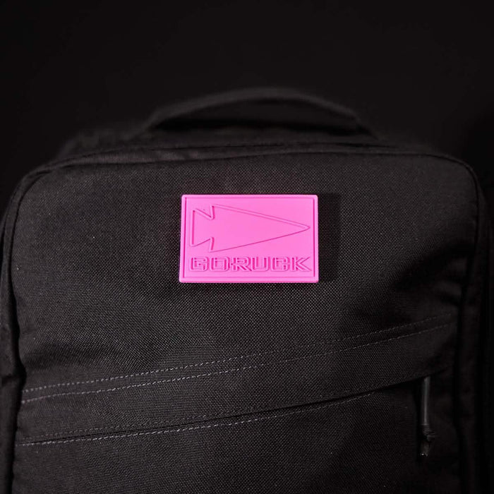 GORUCK black backpack with pink logo patch on front, tough rucking gear