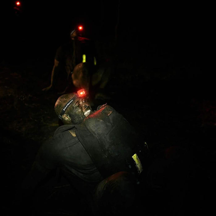 GORUCK rucker with reflective bands and headlamp participating in night rucking event