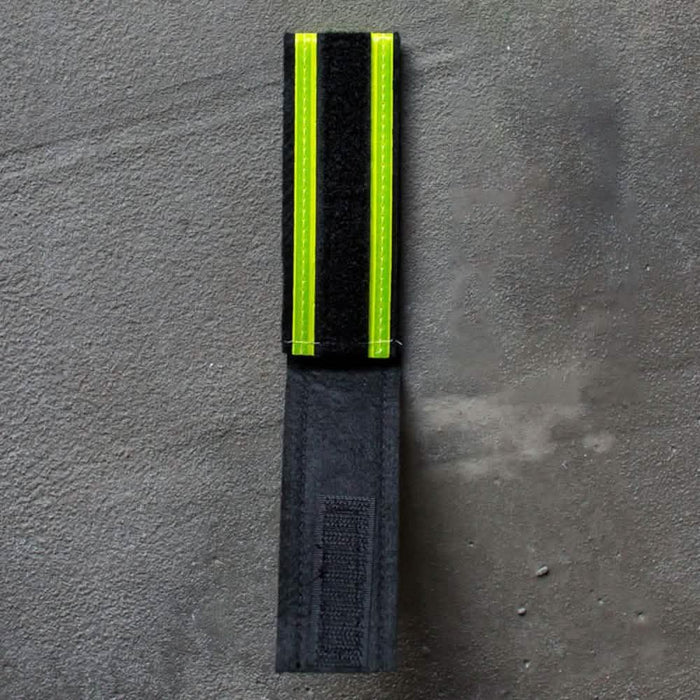 GORUCK reflective ruck band with velcro, black and neon yellow, on concrete surface