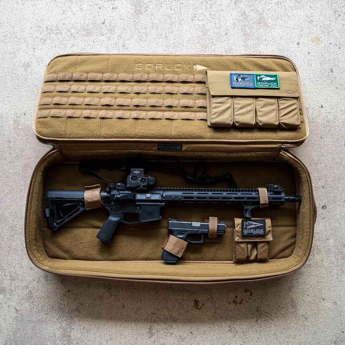 A Rifle Case in tan holds a rifle and a handgun securely, featuring organized compartments for storage.