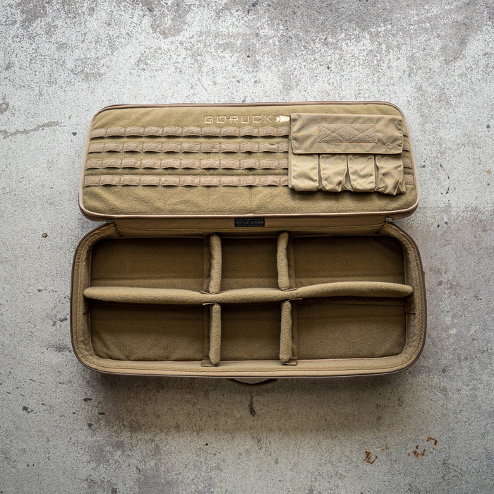 Tan, padded modular Rifle Case with compartments and MOLLE panel shown open on a textured concrete surface; compatible with hard cases for enhanced protection.
