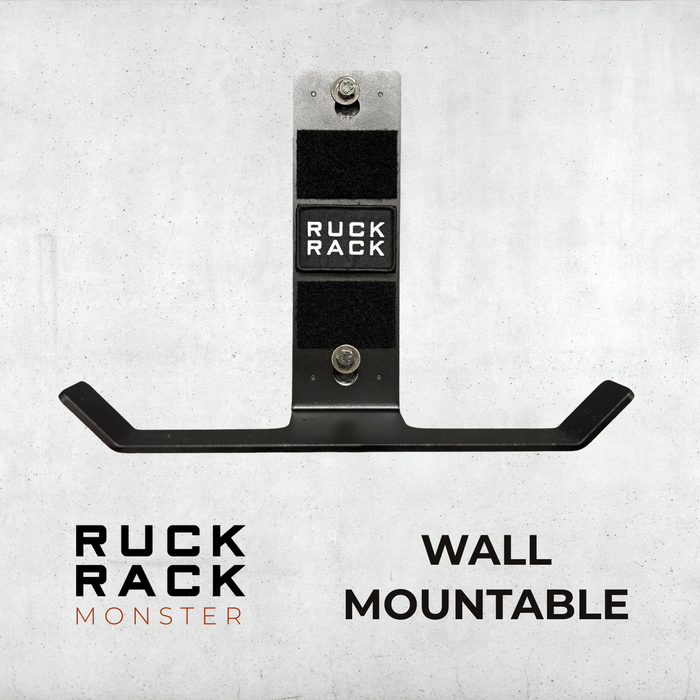 Ruck Rack® Monster—versatile wall-mount for rucks, weight vests, and tactical gear—displayed in black with bold “RUCK RACK” branding against a gray backdrop. Text reads “WALL MOUNTABLE.” The ultimate organizer for your American-made gear storage needs.