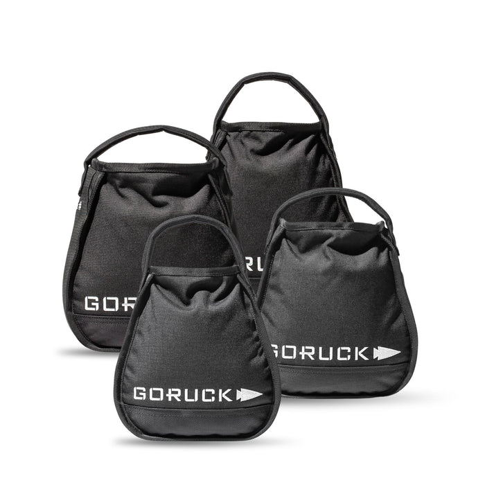 Four black GORUCK Kettlebell Bundle sandbags of different sizes with handles, grouped on a white background—each built tough like portable sand kettlebells and backed by a lifetime guarantee.