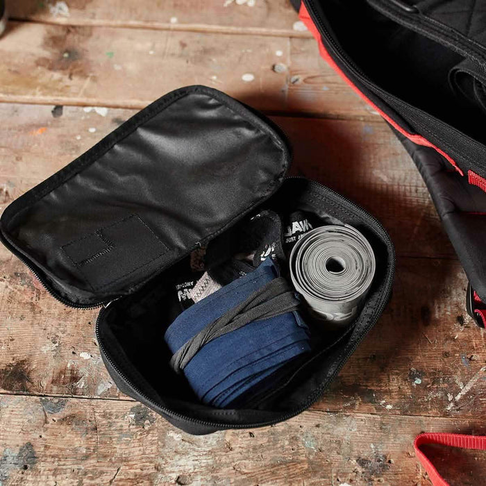 GORUCK Shadow Pocket M gym gear pouch open on rustic table with organized fitness accessories