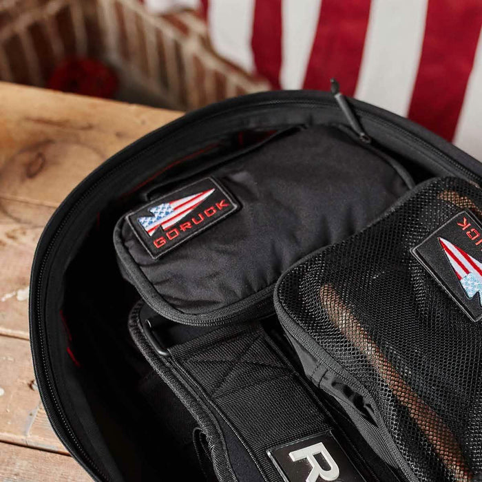 GORUCK Shadow Pocket M inside open rucksack with American flag patch and rugged packing gear