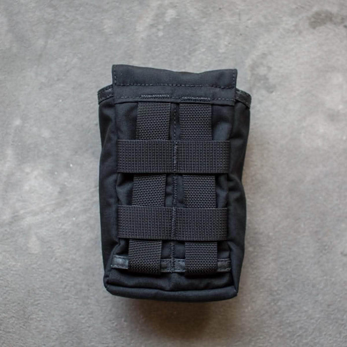 GORUCK black side pocket pouch with MOLLE webbing on concrete background
