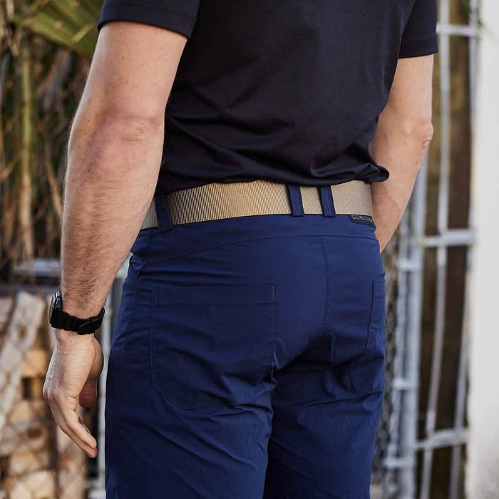 GORUCK tactical coyote belt worn with navy pants, outdoor setting, back view
