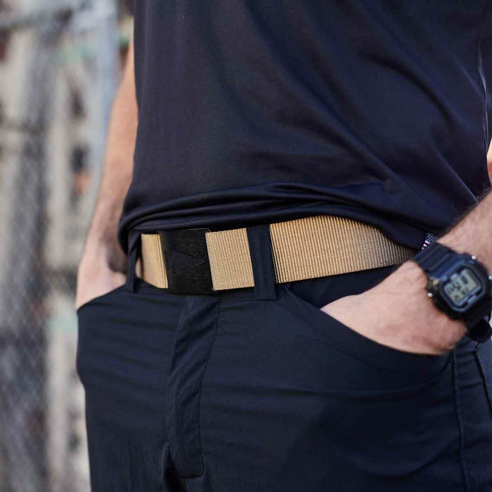 GORUCK tactical coyote belt worn with black pants and watch, outdoor setting