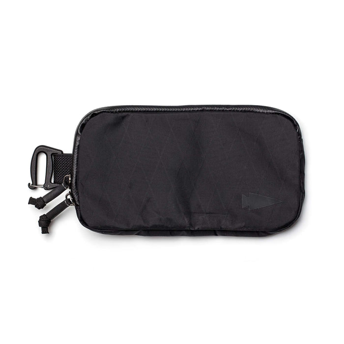 The Sternum Pouch - X-PAC is a black pouch featuring a carabiner clip, dual zipper pulls, and an arrow logo on the bottom right corner.