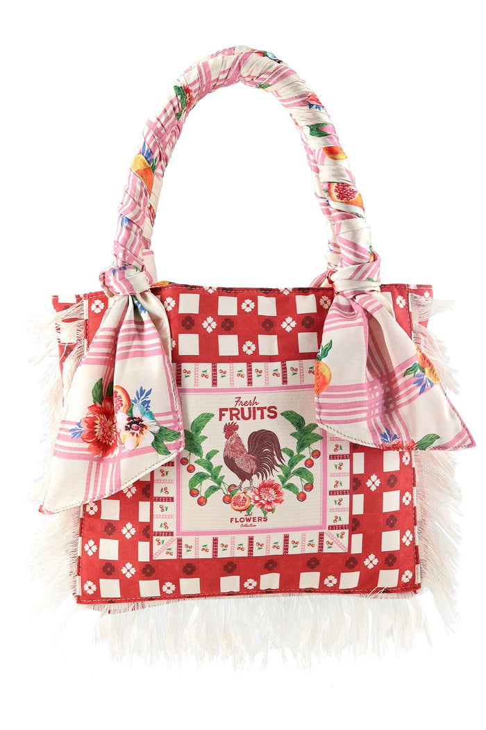 Red and cream tote bag with checkered pattern, rooster and fruit print on front panel, pink striped twisted handles with pattern detail accents, and…