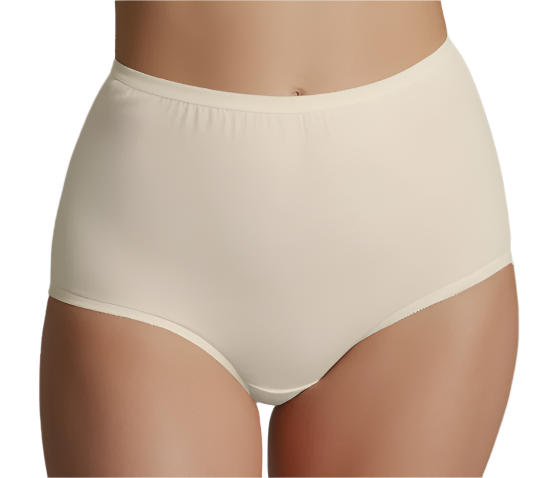 A model wears The Classic Betsy (M100) high waist brief by Teri Lingerie in light beige, shown from waist to upper thighs against a plain background, highlighting the modest fit and full coverage cotton panty style.