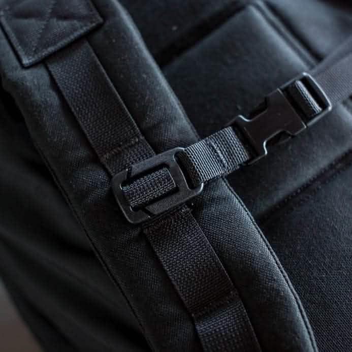 Close-up of GORUCK rucksack durable black strap and buckle, rugged rucking gear.