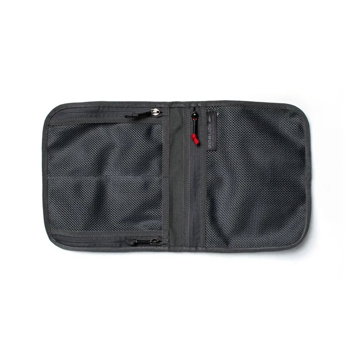 The Wire Dopp is a gray, zippered mesh travel organizer with two compartments, shown open on a white background—ideal as an EDC pouch or cable storage bag.